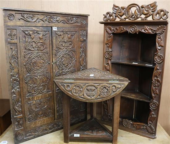 Two carved oak corner cupboards and occasional table W.70cm,55cm,53cm